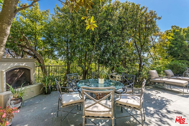 view of patio with an outdoor fireplace