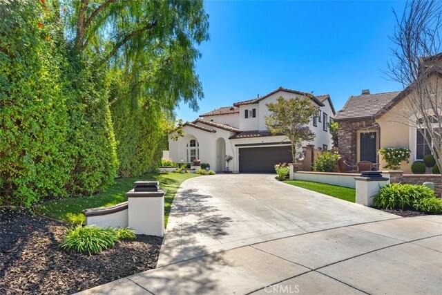 mediterranean / spanish-style home with a garage