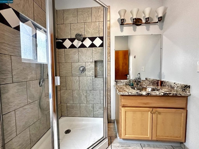 bathroom with an enclosed shower and vanity