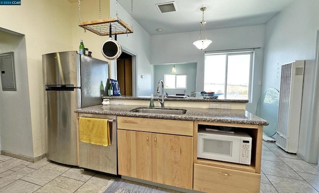 kitchen featuring pendant lighting, light tile patterned flooring, sink, appliances with stainless steel finishes, and light brown cabinetry