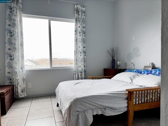 bedroom featuring light tile patterned floors