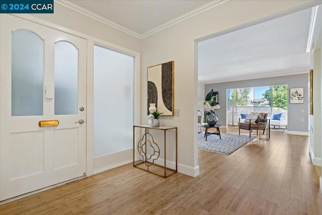 entrance foyer with crown molding and hardwood / wood-style flooring