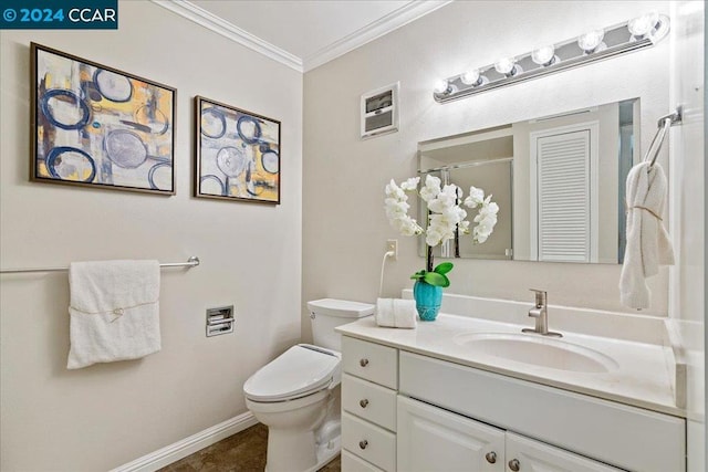 bathroom featuring vanity, crown molding, and toilet