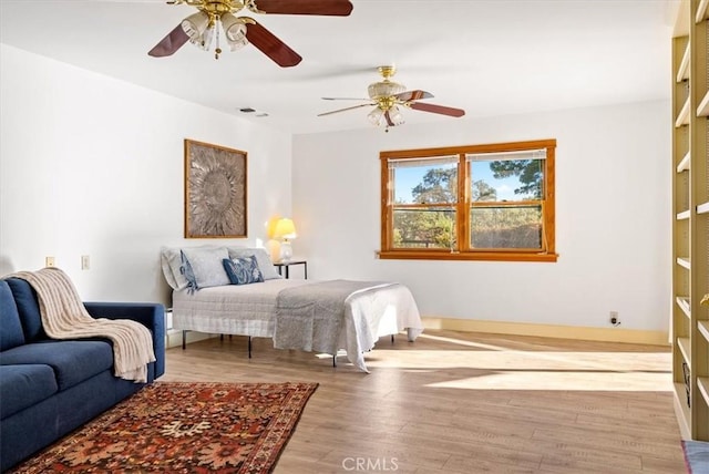 bedroom featuring light wood-type flooring and ceiling fan