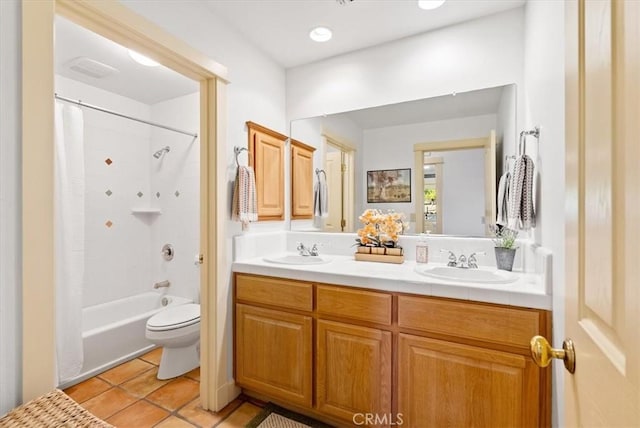 full bathroom featuring toilet, tile patterned floors, vanity, and bathing tub / shower combination