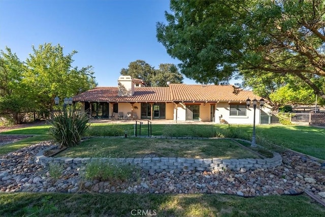 back of house with a lawn