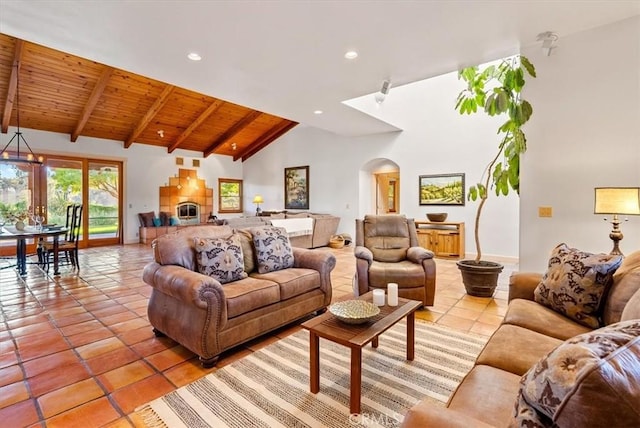 tiled living room featuring a fireplace, beam ceiling, high vaulted ceiling, and wooden ceiling