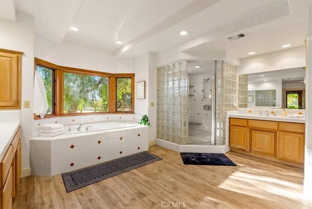 bathroom featuring vanity, wood-type flooring, and shower with separate bathtub