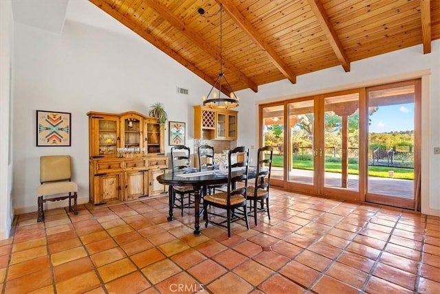 tiled dining room featuring beam ceiling, wooden ceiling, high vaulted ceiling, and french doors