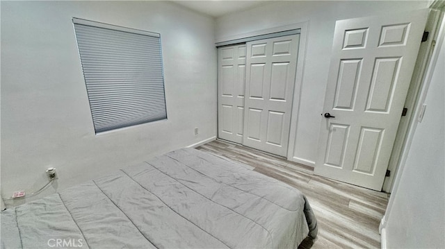 bedroom featuring a closet and light wood-type flooring