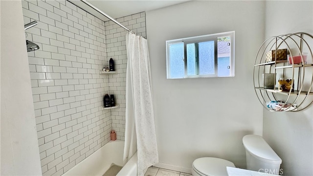 bathroom with shower / bathtub combination with curtain, tile patterned floors, and toilet