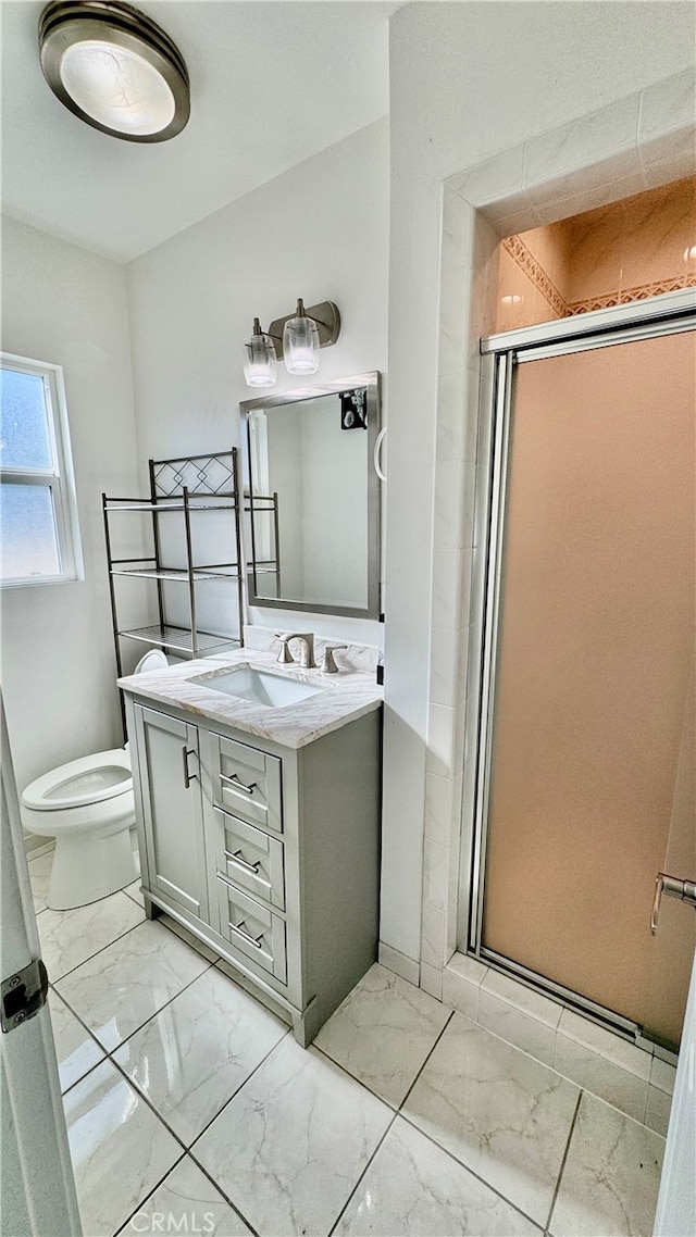 bathroom featuring walk in shower, vanity, and toilet