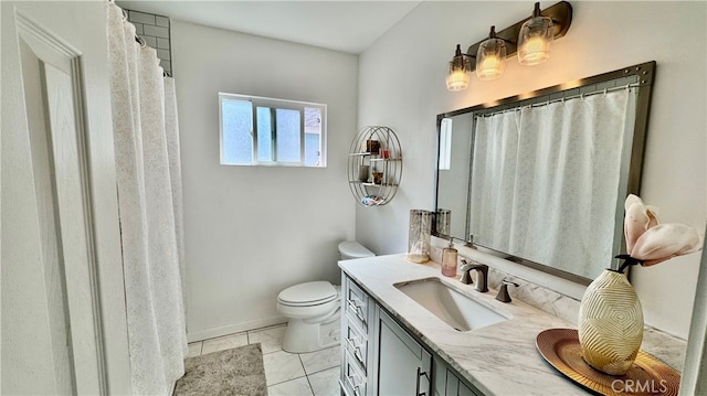 bathroom with tile patterned floors, vanity, and toilet