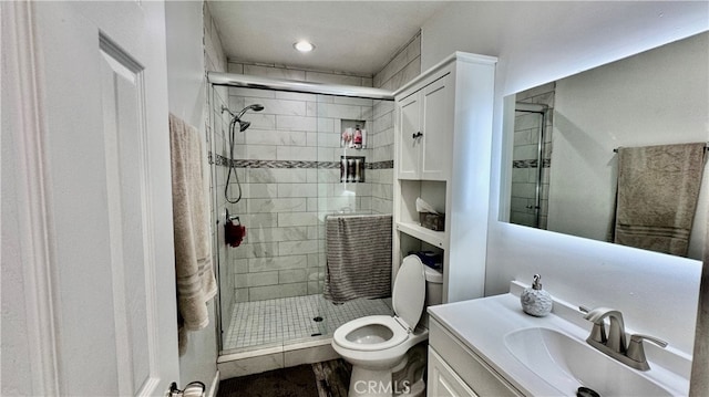 bathroom with walk in shower, vanity, and toilet