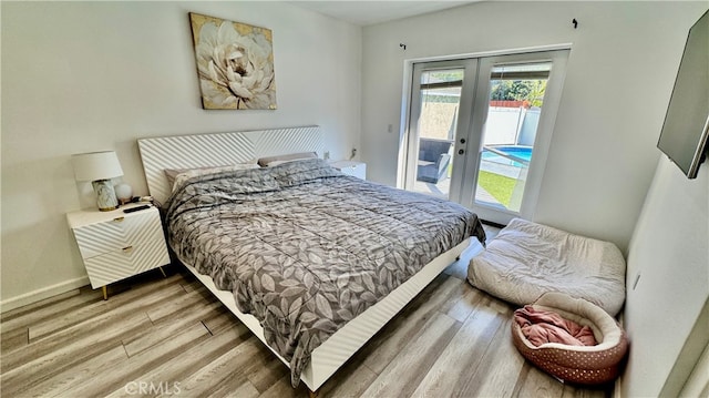 bedroom with wood-type flooring, french doors, and access to exterior