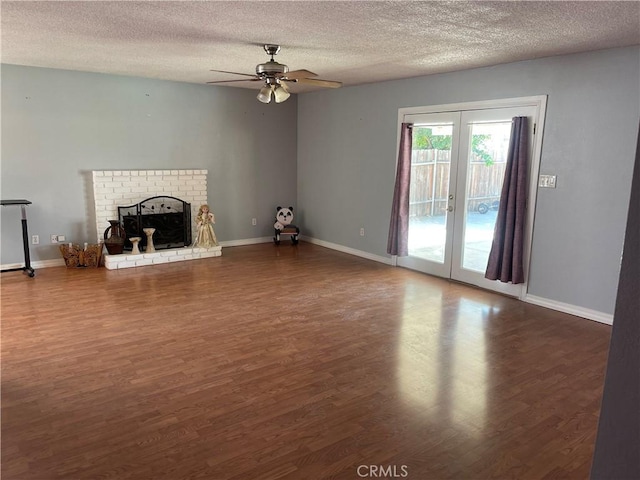 unfurnished living room featuring a textured ceiling, dark wood-type flooring, and french doors