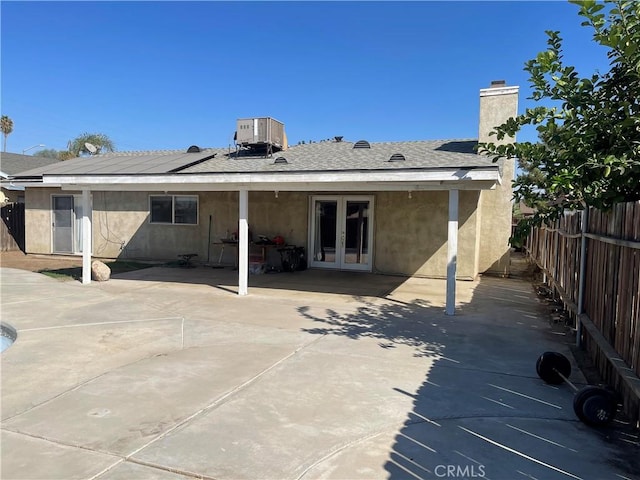 back of house with a patio area, french doors, and cooling unit