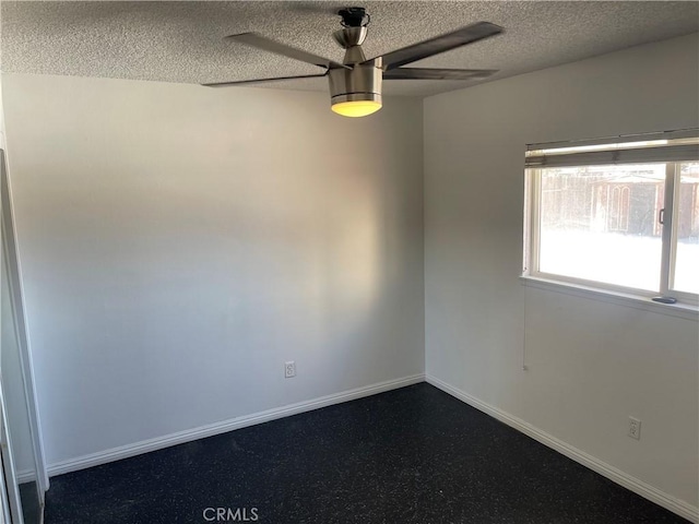 empty room featuring a textured ceiling and ceiling fan