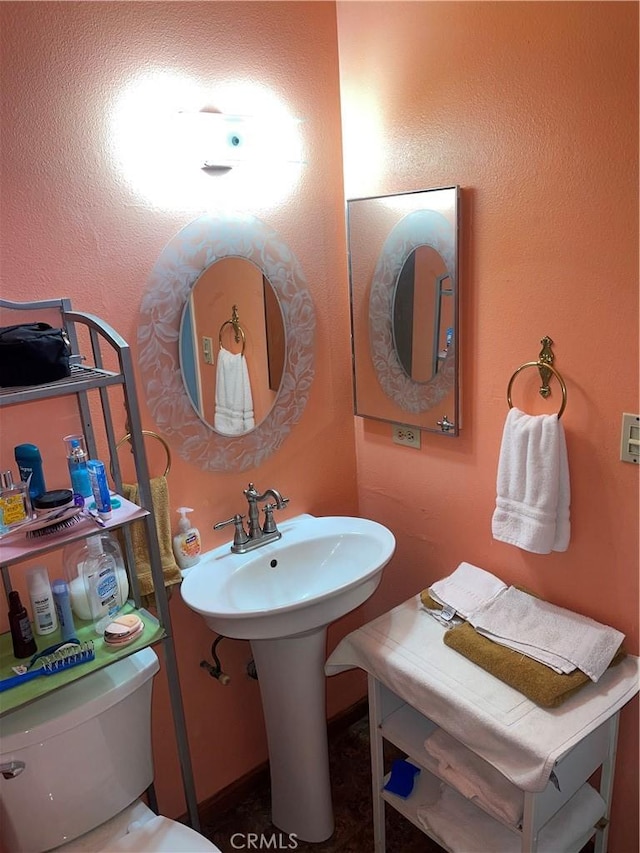 bathroom featuring toilet and sink