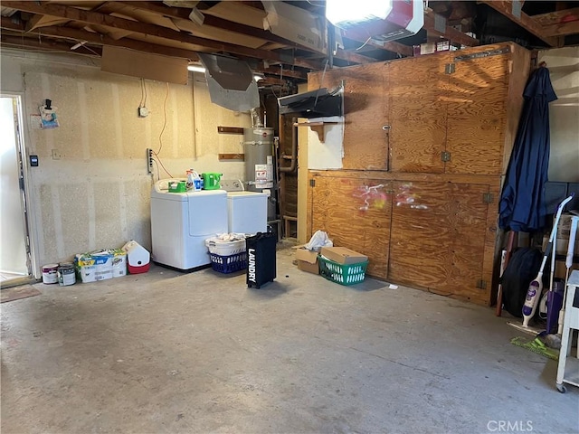 basement with washing machine and dryer and strapped water heater