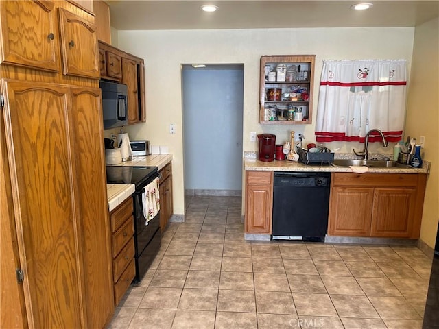 kitchen with black appliances, light tile patterned floors, and sink