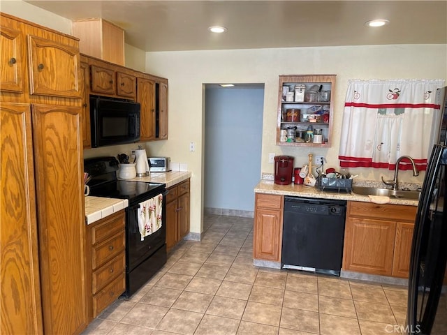 kitchen with sink, light tile patterned flooring, and black appliances