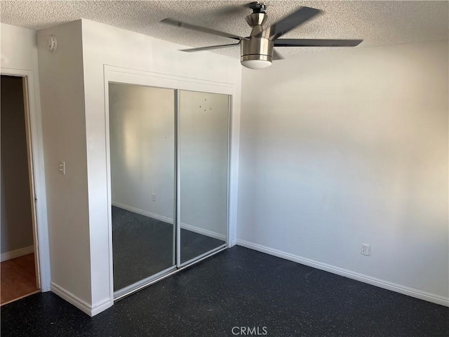 unfurnished bedroom featuring a textured ceiling, a closet, and ceiling fan