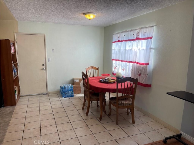 dining room featuring light tile patterned floors and a textured ceiling