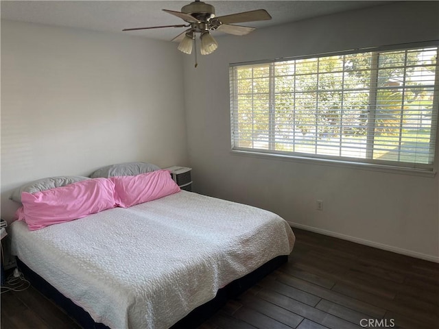 bedroom with ceiling fan and dark hardwood / wood-style flooring