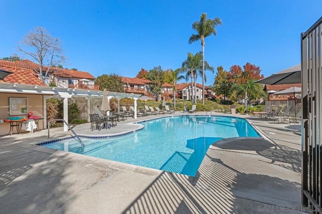 view of swimming pool with a pergola and a patio