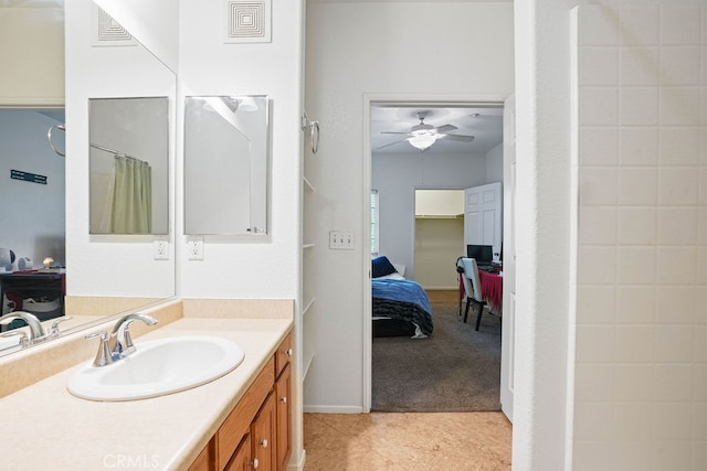 bathroom featuring tile patterned flooring, vanity, curtained shower, and ceiling fan