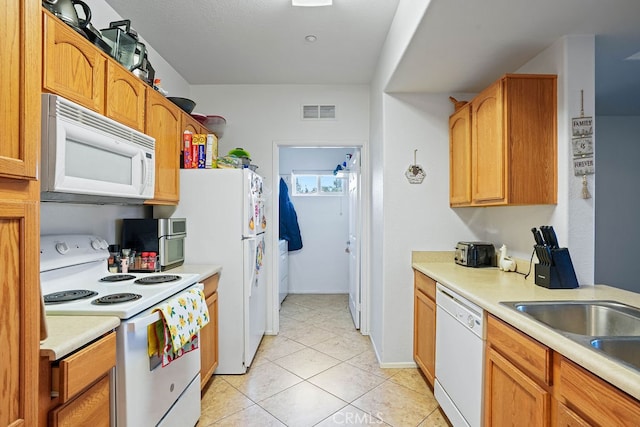 kitchen featuring white appliances and light tile patterned flooring