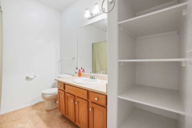 bathroom featuring tile patterned flooring, vanity, and toilet