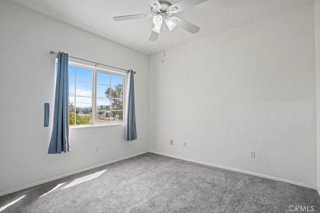 carpeted empty room featuring ceiling fan