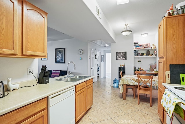 kitchen featuring dishwasher, light tile patterned floors, and sink