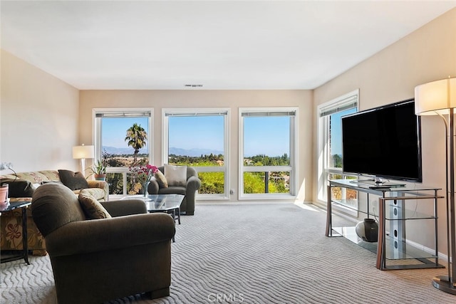 living room featuring carpet flooring and a healthy amount of sunlight