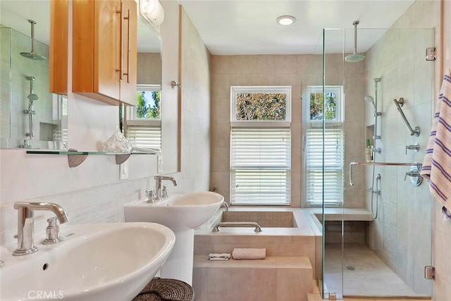 bathroom with separate shower and tub, plenty of natural light, sink, and tile patterned floors