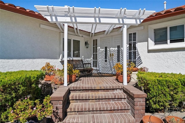 entrance to property featuring a pergola