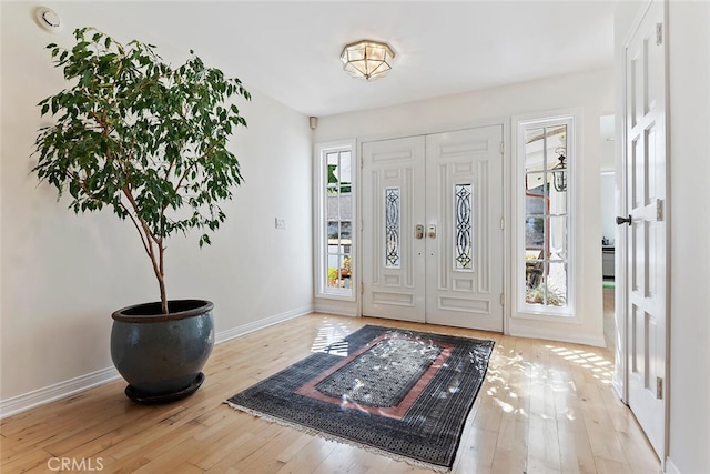 foyer entrance with light hardwood / wood-style floors