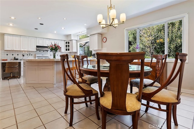 tiled dining space featuring a notable chandelier