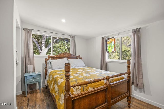 bedroom featuring dark hardwood / wood-style floors and lofted ceiling