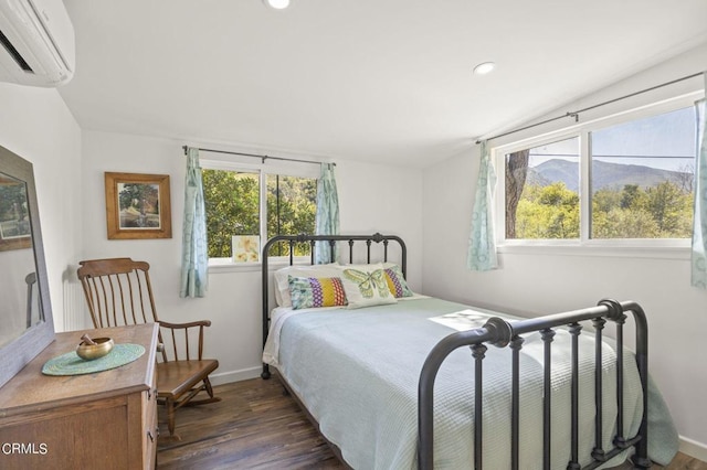 bedroom featuring an AC wall unit, multiple windows, and dark hardwood / wood-style flooring