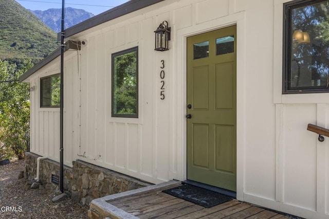 view of exterior entry with a mountain view