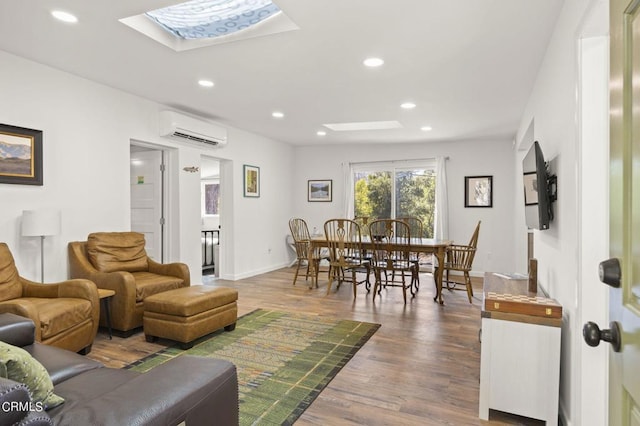 living room with a skylight, wood-type flooring, and a wall mounted AC