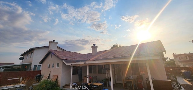 view of back house at dusk