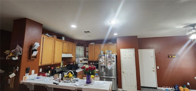 kitchen with tile countertops, stainless steel fridge, and ceiling fan