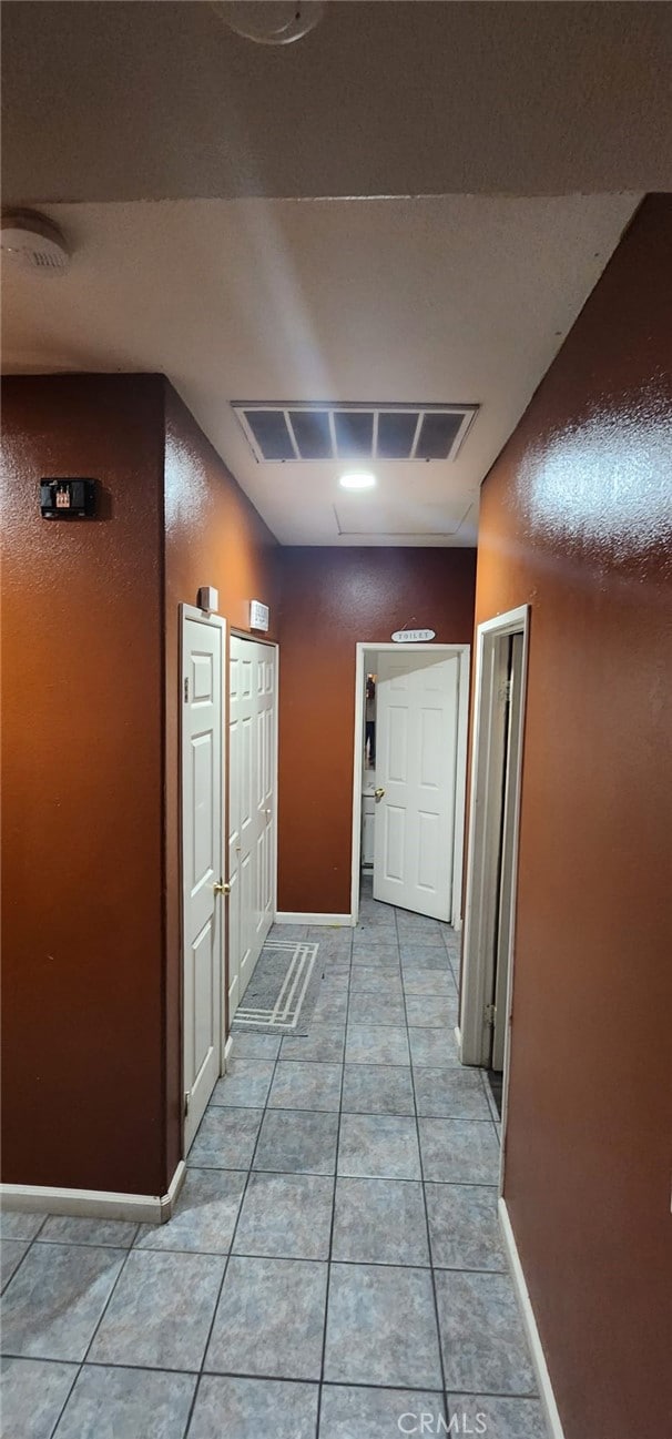 hallway with light tile patterned floors