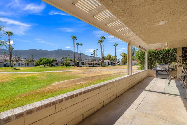 view of patio with area for grilling and a mountain view