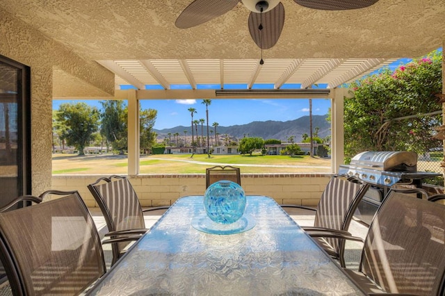 view of patio / terrace with ceiling fan, a mountain view, and a pergola