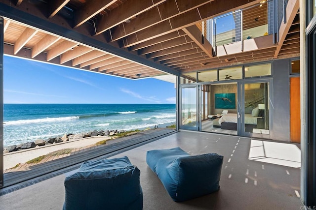 view of patio / terrace with a view of the beach and a water view